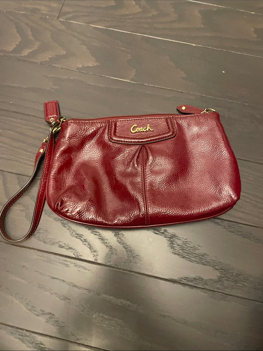 Coach Leather Wristlet in Deep Burgundy with Gold Logo